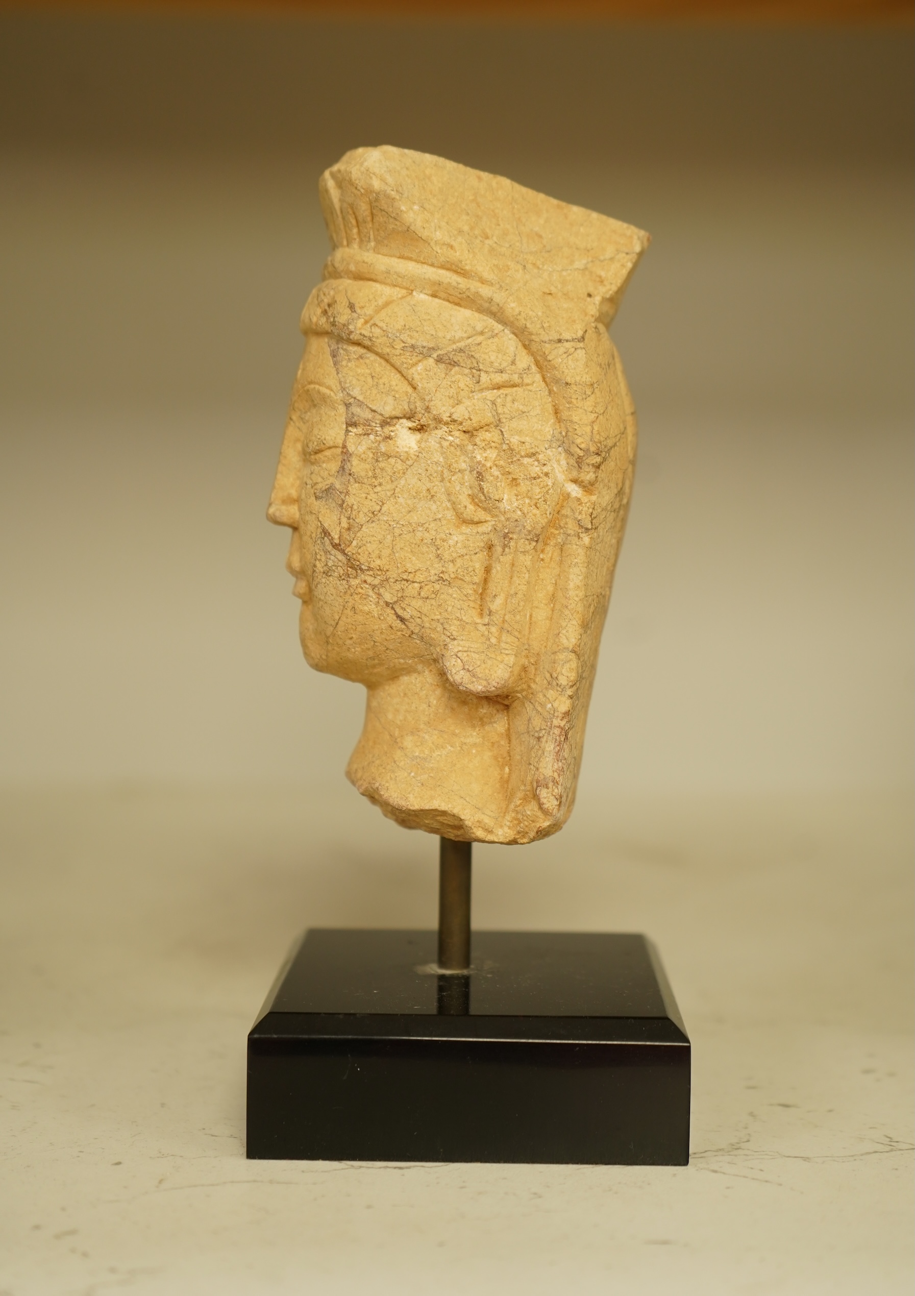 A composition bust of Bodhisattva, possibly Tibetan, on stand, 18cm high